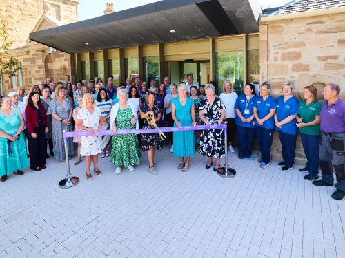 Tracy Flynn cuts the ribbon to officially open the building to the community